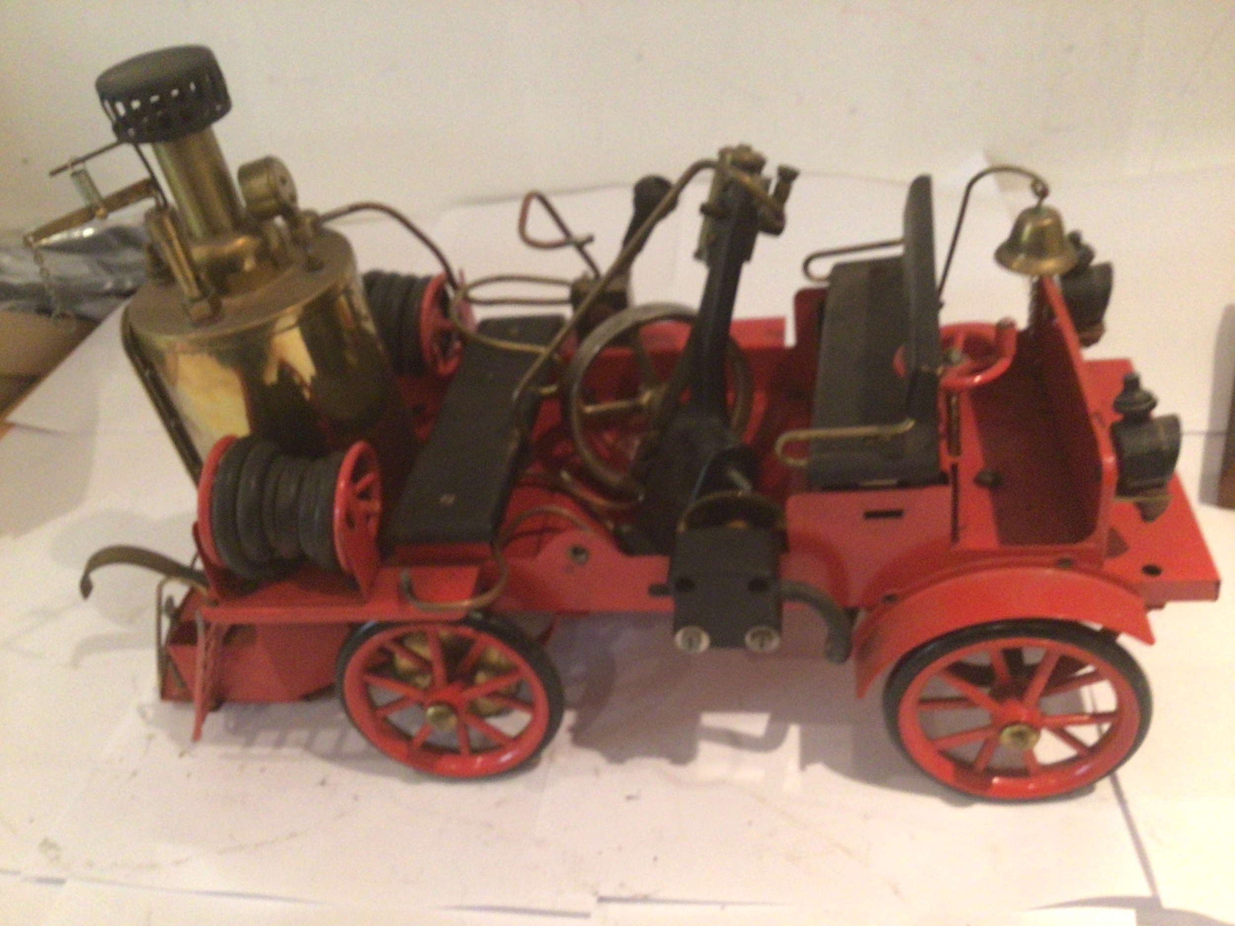 A model steam powered vintage fire engine by Wilesco, part dismantled.  Untested