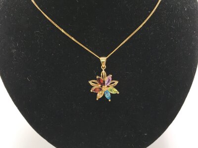 A 9ct gold necklace with a star pendant set with coloured stones.
3.40g