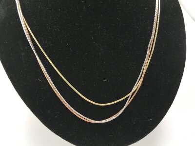 A 9ct multi coloured three strand gold necklace.
10.14g