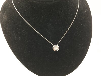 A 9ct white gold necklace with stone set pendant.
2.09g