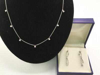An 18ct white gold necklace and earring set with small diamonds.
