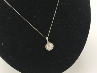 A 9ct white gold necklace set with a CZ pendant.
1.79g