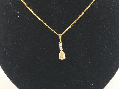 An 18ct pendant set with yellow diamond on a 9ct gold chain.
3.35g