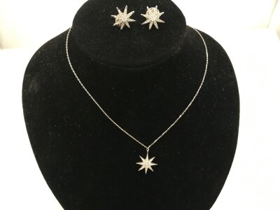 A 9ct white gold necklace with star pendant and matching earrings.