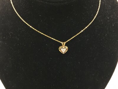 An 18ct yellow gold necklace with a heart shaped diamond in small pendant.