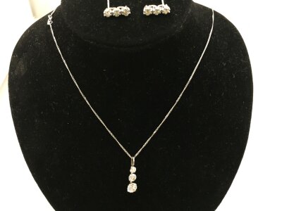 A 9ct white gold chain set with three CZ stone set pendant 1.21g and a pair of 18ct white gold diamond earrings 2.15g