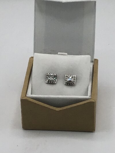 A Pair of 18carat white gold diamond earrings the raised central stones Princess cut flanked by small stones