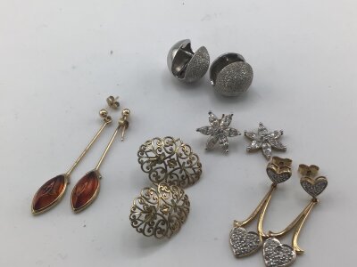 Four pairs of 9carat gold earrings set with amber and CZ stones weight 8g approximately and pair of modern design white metal spherical earrings