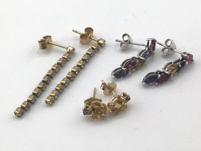 Three pairs of 9cart gold earrings white gold set with multi coloured stones a pair with cut Citroens and and one other pair of long drop earrings.