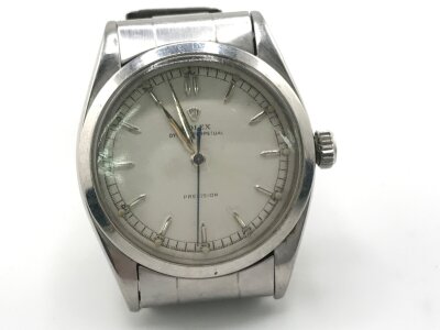 A vintage Rolex 6298 Oyster perpetual stainless steel white dial watch. Comes with rivet link oyster bracelet. 
36mm case. Winds and runs.
No box or papers