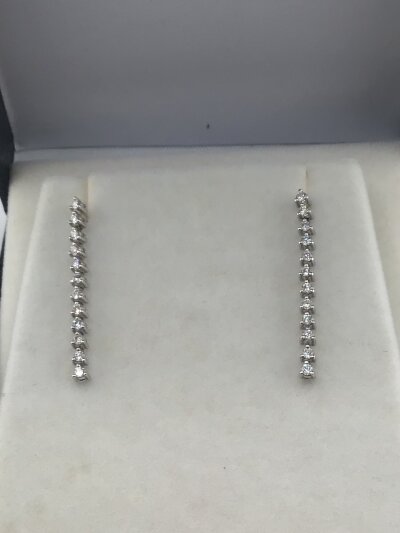 A pair of 18carat gold diamond set long drop earrings each earring with twelve diamonds.