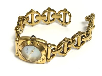 A vintage ladies gucci watch with a mother of Pearl style dial.