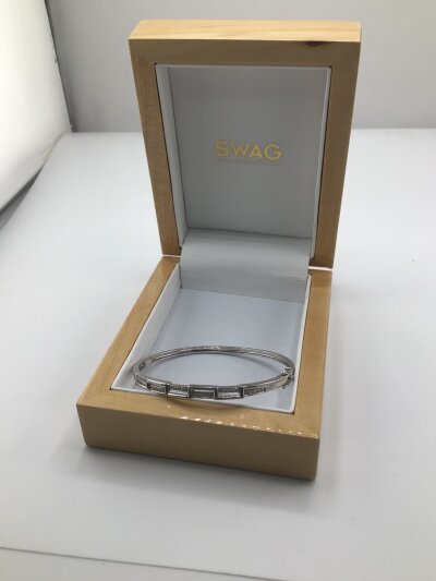 A modern design 9carat gold bangle set with small brilliant cut diamonds approximately 0.2 carat weight 10g