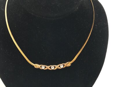 A 9ct gold necklace set with three small diamonds.
5.79g