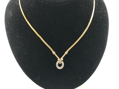 A 9vt yellow gold necklace with a circle of chip diamonds.
6.58g