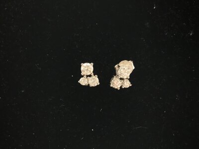 A pair of 9ct white gold three stone diamond earrings.
1.80g