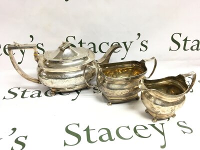 Three piece hallmarked silver tea set, total weight 1065g. tea jug 16cm tall.