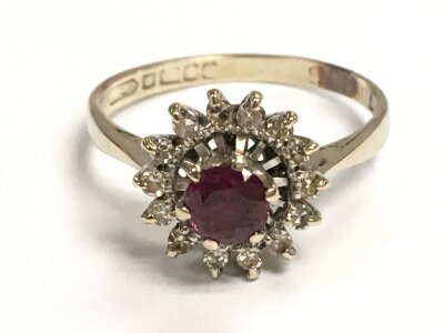 An 18ct gold ring set with ruby and small brilliant cut diamonds, size N ,3.1g total weight