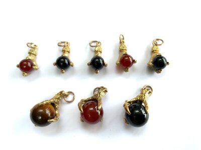 8 various sized eagles claw pendants with agate beads.