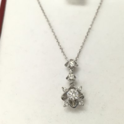 A 14ct white gold diamond solitaire necklace. Postage B