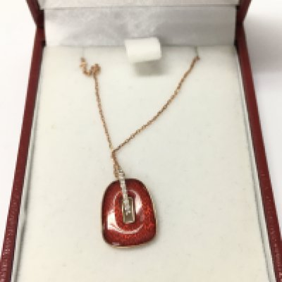 14ct rose gold chain with a red enamel and diamond pendant.