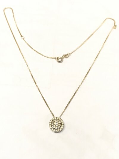 A 18ct white gold pendant (central stone Moissanite , smaller stones diamond) with a silver necklace. 2.7g total weight