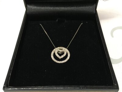 9k white gold heart pendant set with small diamond stones and 10k chain. 0.20ct diamond total