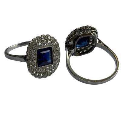 An 18ct white gold and diamond set ring set with a central square cut sapphire and surrounded by 43 x 0.01 pave set diamonds, K.5.