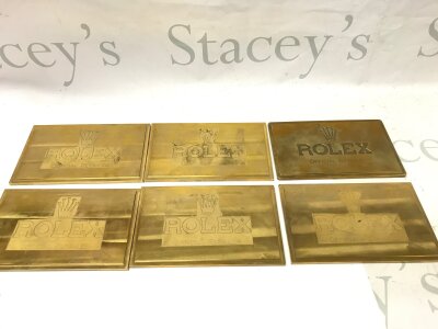 6 brass plates displaying official retailer Rolex.
