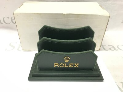 A Rolex display catalogue book holder stand from dealership.