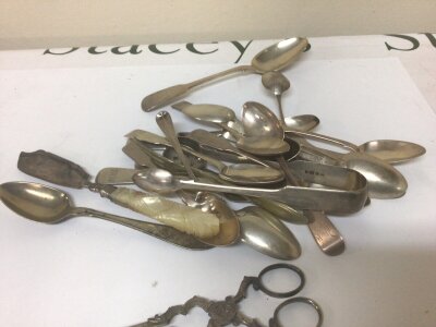 A collection of mixed silver cutlery and a pair of unmarked white metal George III sugar tongs. Total weight approximately 500g
