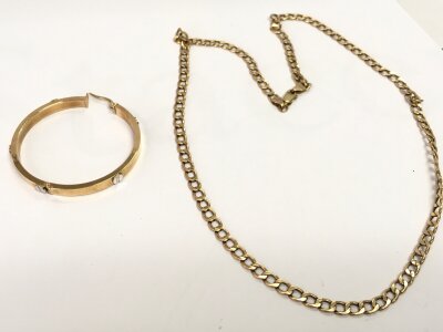 A 9ct gold chain and a 9ct Cartier style earring. 7.8g total weight,