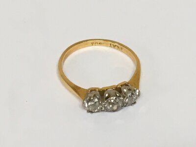 An 18carat gold ring set with three old cut diamonds weight 2g ring size M.
