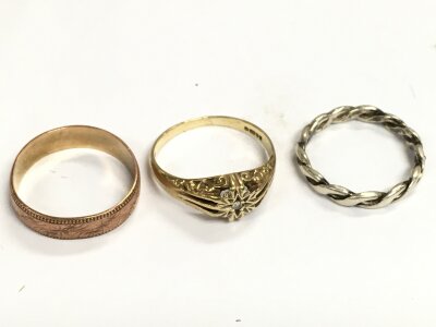 Two 9ct gold rings and a silver ring (3). Gold weight 4.4g total. Size O
