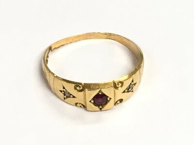 An 18ct gold ring set with a ruby stone and small diamonds size L. 2.3G total weight