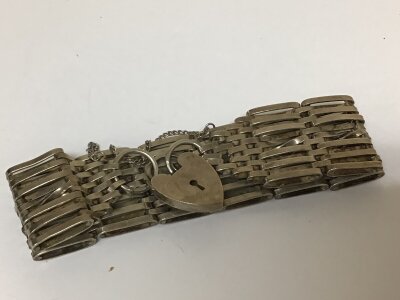 A Silver gate bracelet with heart shaped padlock clasp. Weight 48g