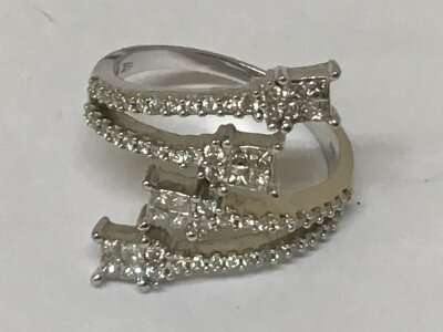 A Modern design 18carat gold ring with four open scrolls all pave set  with brilliant cut diamonds total carat weight 0.90 of a carat ring size U-V. Total weight 7g