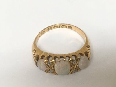 An Antique 18carat gold ring set with three opals ring size M weight 4g