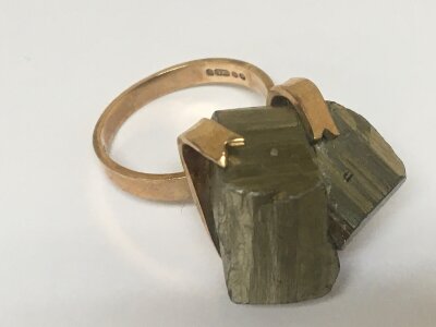 A 9carat gold ring mounted with a raw natural metal. Total weight 15g