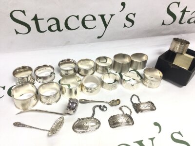 A collection of silver hallmarked napkin rings, wine label’s , spoons. 470g total weight
