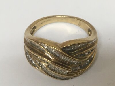 A 9carat gold ring set with intertwined rows of baguette diamonds weight 6g ring size U.