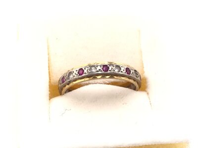 An 18ct gold eternity ring set with diamonds and rubies.
3.60g and size P