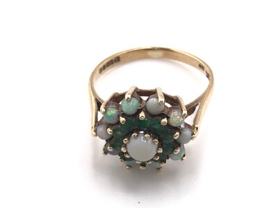 A 9ct gold ring set with Opals and emeralds
Size M and 3.30g