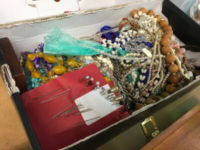 A box of mixed costume Jewellery including necklaces, pins etc