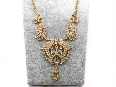 A high carat gold (unmarked) necklace set with white sapphires. Possibly Indian made. 
34.27g