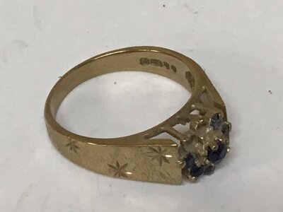 A 9carat gold ring set with dark blue sapphire (stones missing) weight 3.5g
