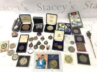 A collection of assorted medals medallions and coins