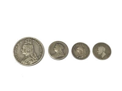A 1891 full crown along with three other silver coins.