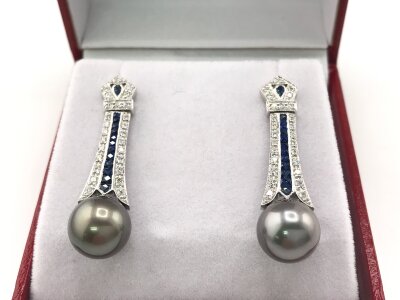 A pair of 18ct white gold art deco style long drop earrings set with Tahitian pearls sapphires and diamonds.