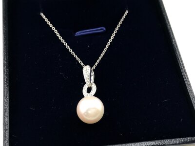 A 9ct white gold pendant set with diamond art deco style bales with spherical cultured Pearl on 9ct white gold chain.
